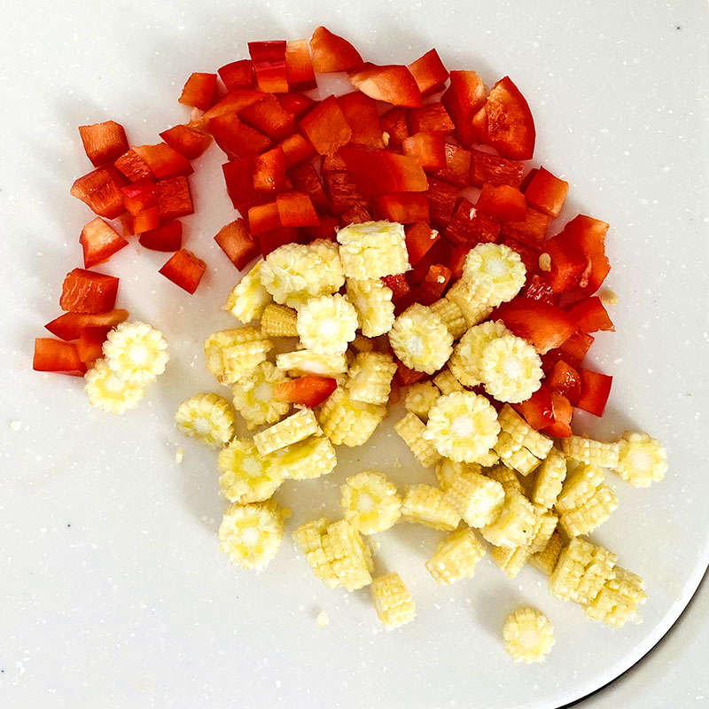 Chop the baby corn and red pepper.