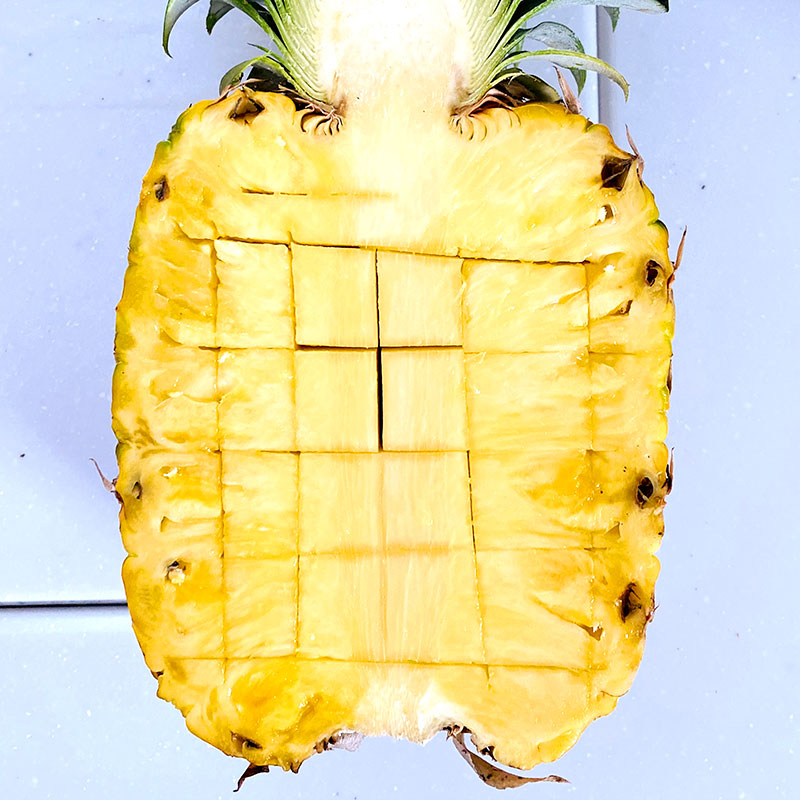 Halve the pineapple and cut it into a bite size squares.