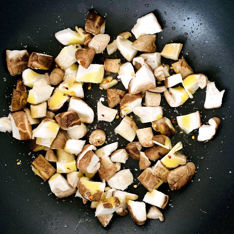 Add chopped mushrooms to the preheated frying pan and stir - fry for about 5 min.