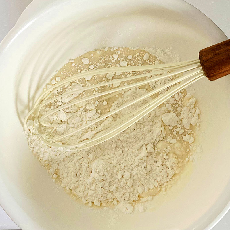 In a mixing bowl, whisk flour, soy milk and baking powder.