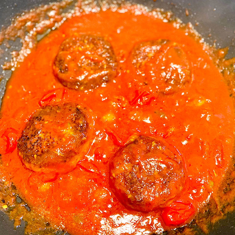 Add the SoMeat Cheese Hamburg Steaks to the tomato sauce and heat everything together for about 2 minutes. Serve warm.