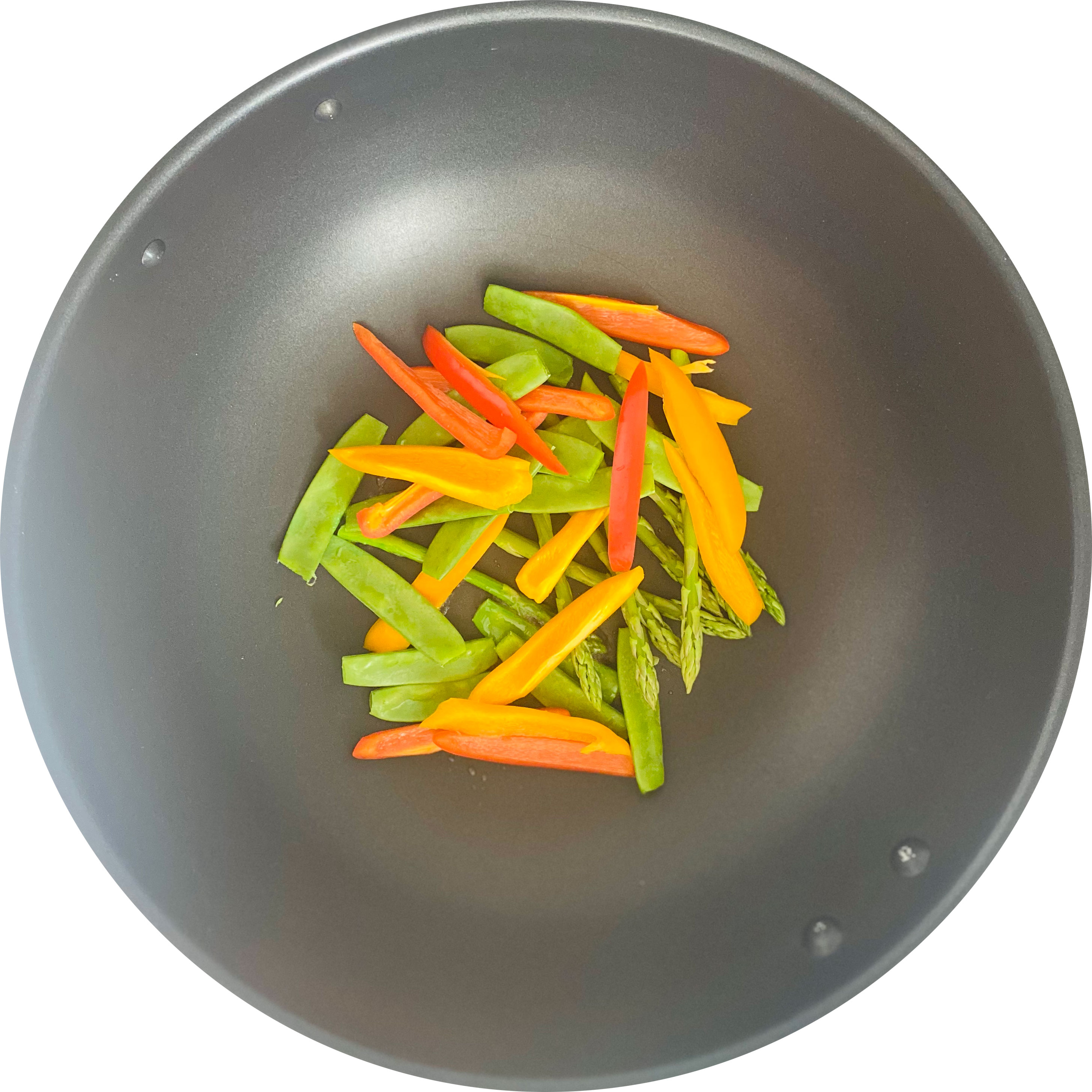 In a wok sauté the bell peppers, baby asparagus and sugar snap peas.
